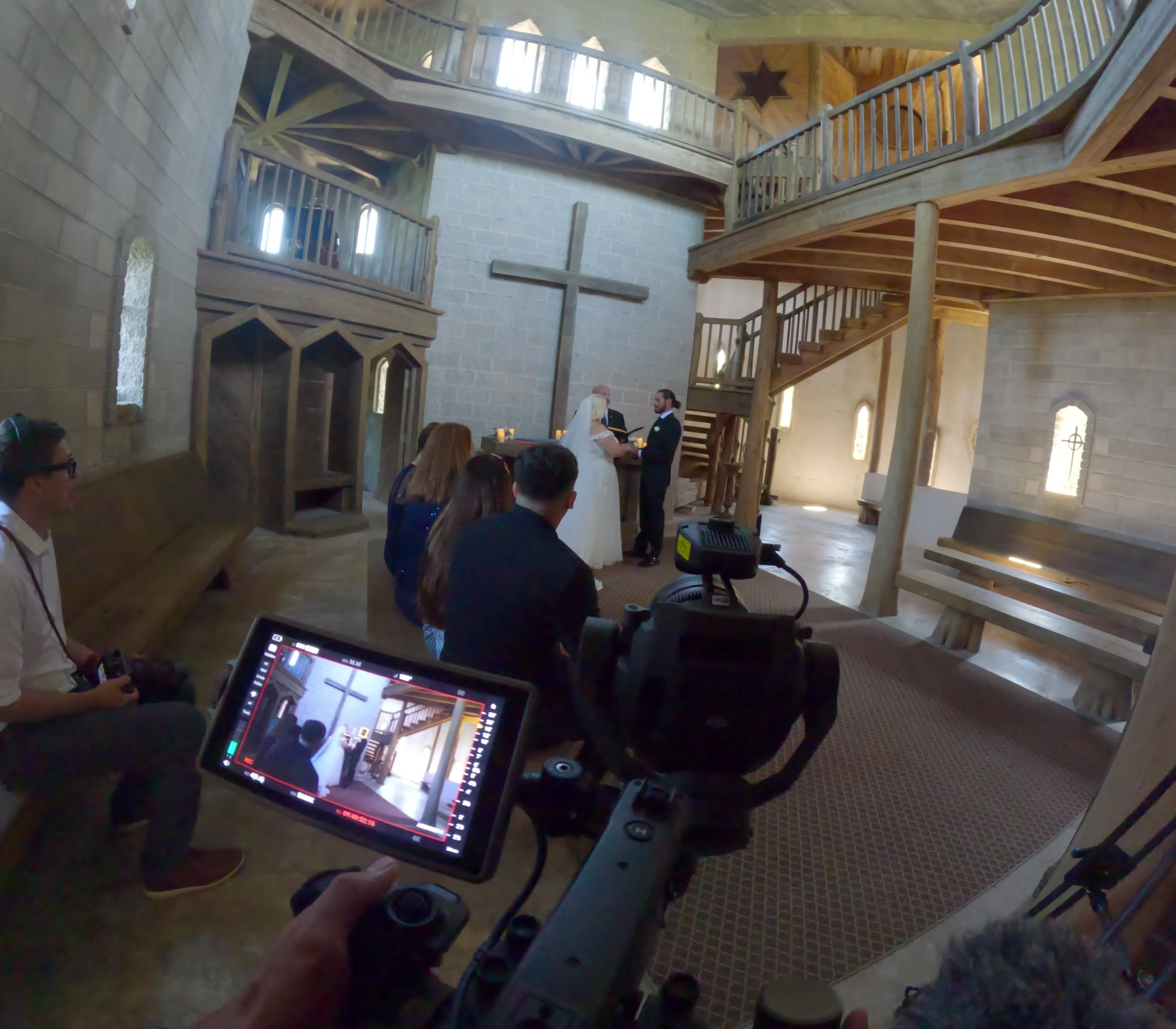 Documentary wedding filmmaker recording from the back of Castle Otttis